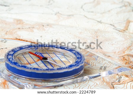 Low angle view of a compass on a topographic map