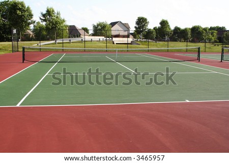 Tennis court playing surface and net