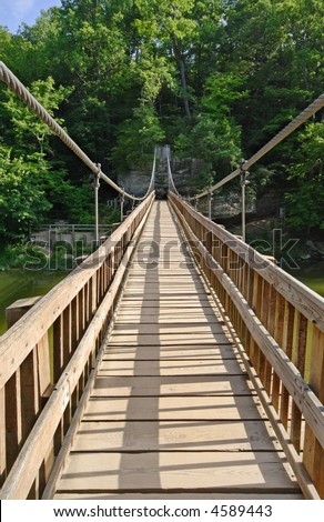 Suspension cable foot bridge on a hiking trail, water below