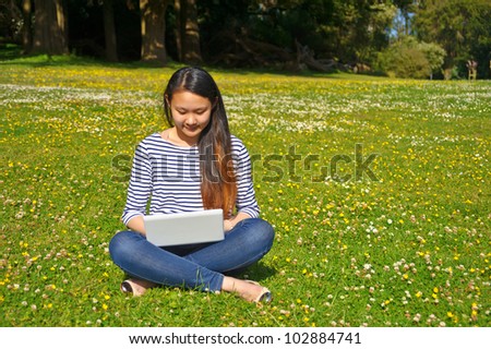 girl with laptop on flower grass