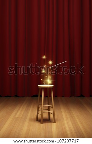 Magic on stool in spotlight on stage of the theater