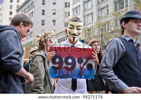 SAN FRANCISCO - OCT 15: An unidentified protester member of Anonymous holding anti government banner during the Occupy protest on October 15, 2011 in San Francisco, US