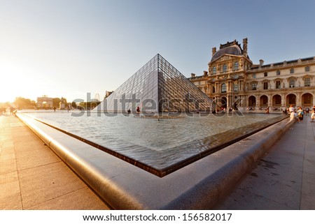 PARIS -AUG 5, 2013      Louvre museum at twilight in summer  AUG 5, 2013 in Paris, France. Louvre Museum is one of the world\'s largest museums, every year museum visits more than 8 million visitors.