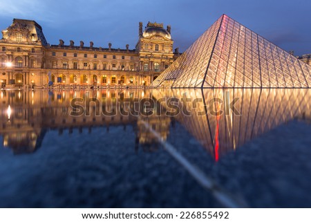 PARIS -JULY 9, 2014 Louvre museum at twilight in summer JULY 9 2014  in Paris, France. Louvre Museum is one of the world\'s largest museums, every year museum visits more than 8 million visitors.