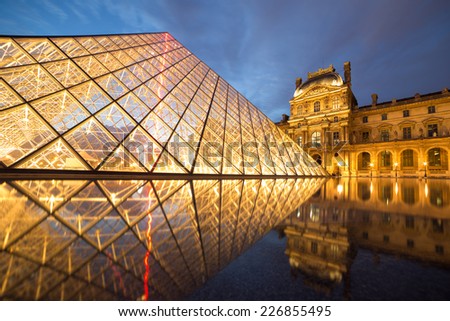 PARIS -JULY 9, 2014 Louvre museum at twilight in summer JULY 9 2014  in Paris, France. Louvre Museum is one of the world's largest museums, every year museum visits more than 8 million visitors.