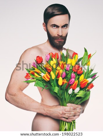 Studio photo middle-aged man with a bouquet of tulips.