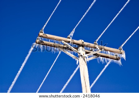 Icicles on telephone wires and top of telephone pole