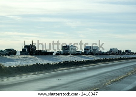 Traffic pile-up caused by snow plows clearing highway after blizzard