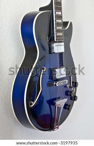 View from left of blue electric jazz guitar