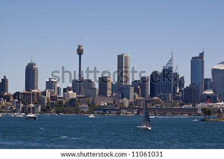 view of city skyline from sydney harbor australia with boats in the foreground