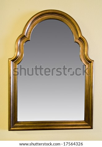 large wall mounted reflective mirror with decorative wooden frame