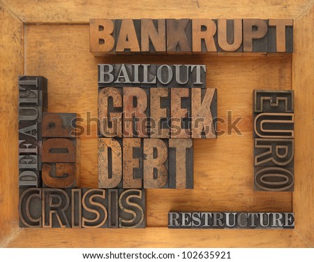 words in letterpress wood and metal type having to do with the Greek debt situation