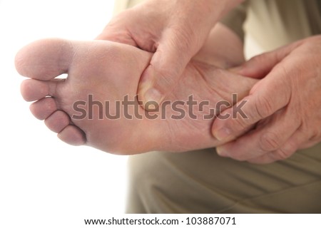 a man checks his aching foot