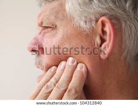 profile of a man suffering from pain in his jaw