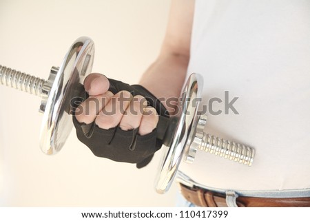 man holds weight in his hand