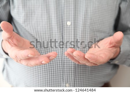 a man gestures with both hands