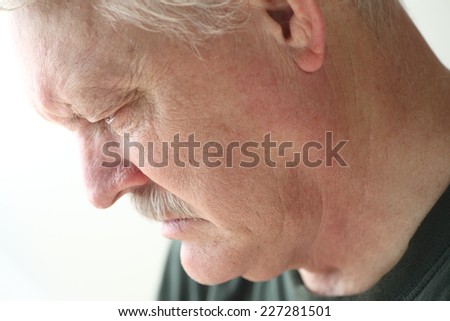Downcast senior man with an expression of sadness, depression or grief