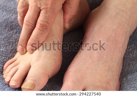 A man with his hand on one foot