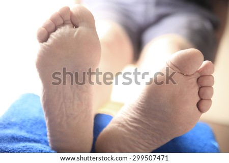 Closeup view of two feet of a man with his legs propped up
