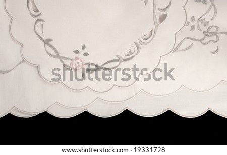 fabric with embroidery and scalloped edges on black