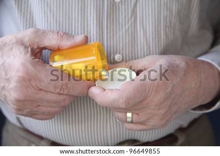 an older man gets ready to take a pill