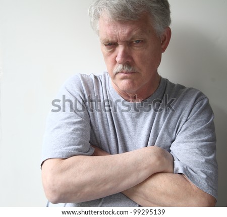 angry older man with his arms crossed