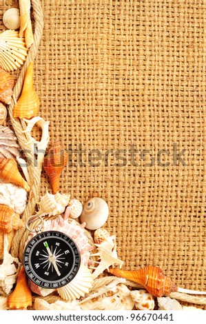 compass on seashell and rope frame on sack