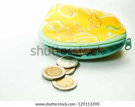 Thai Coins in woman\'s purse on white background.