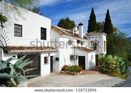 Typical Spanish house is in the middle of large agaves and cactuses