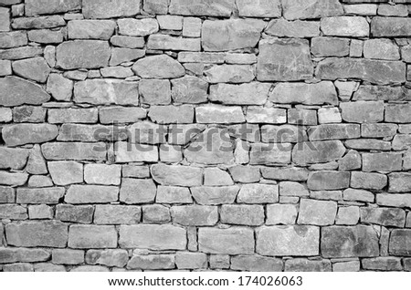 A boundary wall is made from various stones in the ancient Spanish town Ainsa.