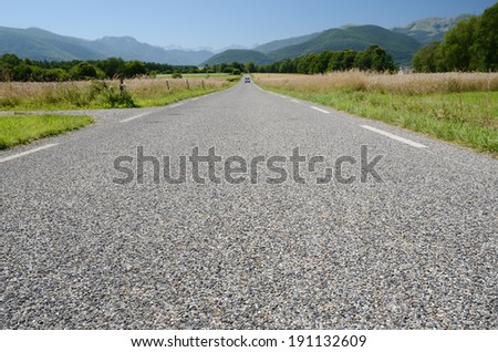 The road surface is photographed close-up with diminishing perspective.