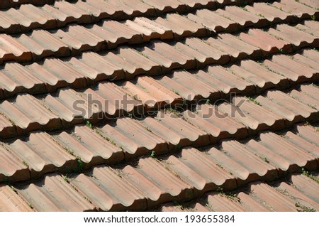 Traditional red tiled roof is sunlit and photographed close-up