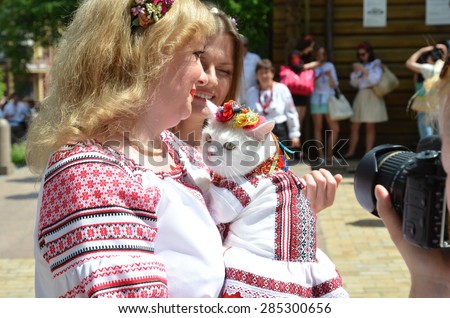 KYIV, UKRAINE - MAY 24, 2015: A woman holds the cat in Ukrainian traditional garments at Mega march of embroideries in KIEV, UKRAINE - MAY 24 2015.