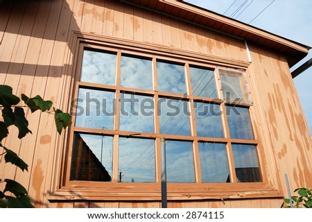 Country house with large windows and wires above it
