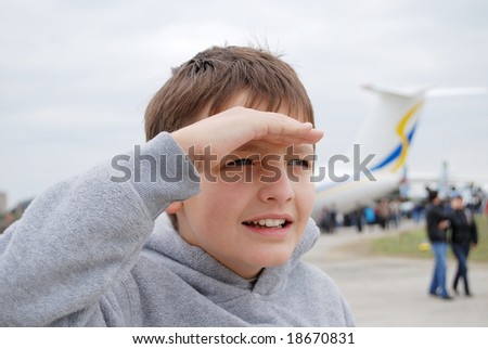 stock photo Preteen boy takes a good look into the distance against 