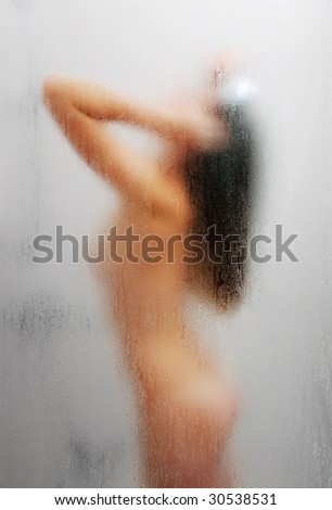 stock photo Blurred silhouette of nude girl washing in shower side view