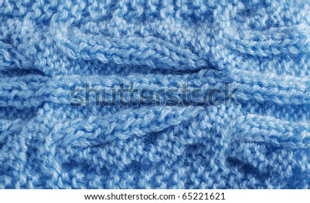 Blue knitted cloth is made by hand. It is decorated with vegetable bulging pattern.