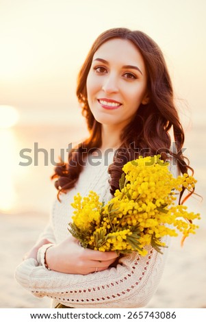 beautiful woman with yellow mimosa