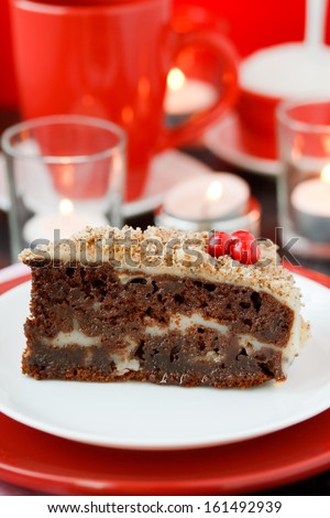 Cocolate cake with nuts on a red background. New Year\'s cake.