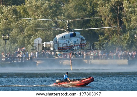 MOSCOW, RUSSIA - AUG 6, 2011: Russian helicopter Kamov Ka-32 Ministry of Emergency Situations ready for takes water from a pond for fire extinguishing. Aug, 6, 2011 in Moscow, Russia