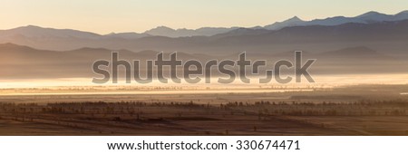 Beautiful natural landscape in dawn rays of the sun over the valley