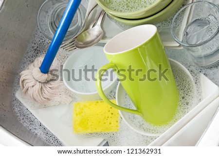 Washing bright dishes in the kitchen sink.