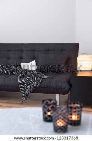 Cozy lights decorating living room with gray sofa.