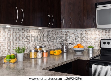 Modern kitchen with cozy lighting, and food ingredients on the counter top.
