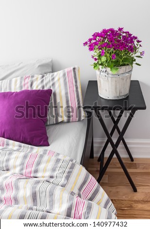 Purple Flowers Decorating A Bright Contemporary Bedroom.
