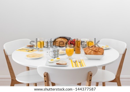 Breakfast for three. Simple tasty morning meal on a white table.