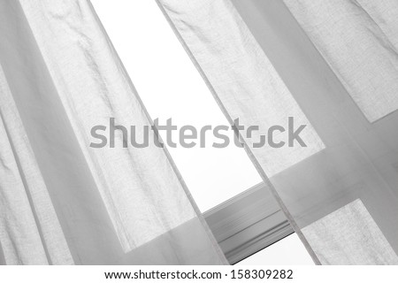 Light coming through the window with white curtains.
