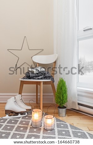 Cozy winter composition in a room, with snowy landscape seen through the window.
