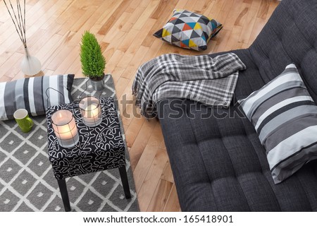 Detail of a bright modern living room with gray sofa.