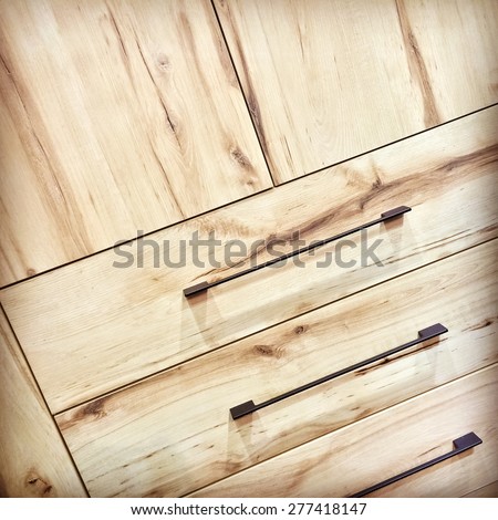 Wooden dresser with metal handles. Contemporary design.